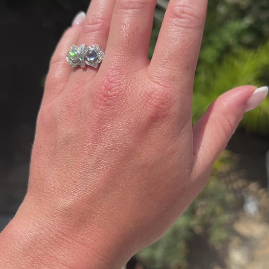 High-definition video capturing the deep blue flashes of the sapphire, the fiery brilliance of the contrasting old-cut diamond, and the sleek geometric lines of the 1920s French Art Deco "Toi et Moi" ring in motion.