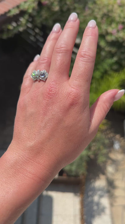 High-definition video capturing the deep blue flashes of the sapphire, the fiery brilliance of the contrasting old-cut diamond, and the sleek geometric lines of the 1920s French Art Deco "Toi et Moi" ring in motion.