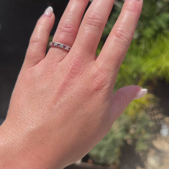 High-definition video capturing the alternating crimson red glow of the rubies, the fiery brilliance of the diamonds, and the warm luster of the 1990s vintage 18k gold eternity ring in motion.