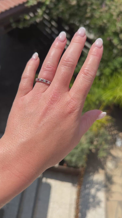 High-definition video capturing the alternating crimson red glow of the rubies, the fiery brilliance of the diamonds, and the warm luster of the 1990s vintage 18k gold eternity ring in motion.