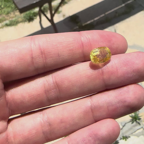 Video showing the intense brilliance, rich canary yellow flashes, and spectacular fiery sparkle of the unheated 6.10ct Ceylon sapphire in motion.