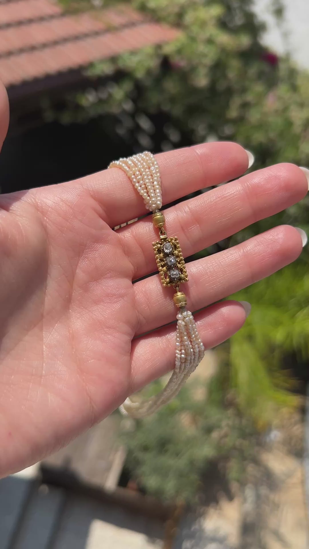 High-definition video capturing the lustrous glow of the multi-strand pearls and the fiery brilliance of the antique old-cut diamonds on the 18k gold Belle Époque choker necklace clasp in motion.