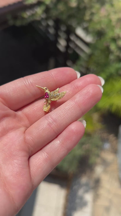 High-definition video capturing the exquisite craftsmanship, fiery diamond brilliance, and rich ruby accents of the vintage E. Wolfe & Co signed and numbered 18k gold hummingbird brooch in motion.