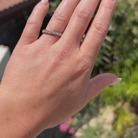 High-definition video capturing the continuous flash, seamless 360-degree fiery sparkle, and geometric engraved detailing of the 2.00-carat antique Art Deco diamond eternity band in motion.