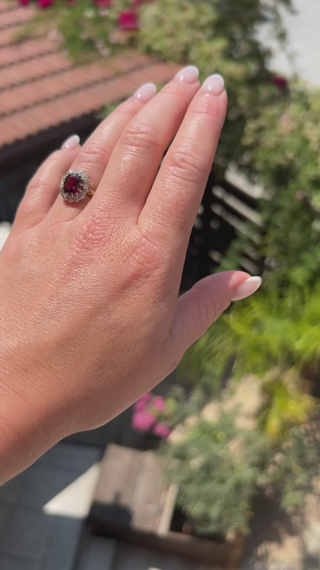 High-definition video capturing the rich raspberry-red flashes of the 2.5-carat rubellite garnet, the fiery brilliance of the 1-carat old-cut diamonds, and the detailed 18k gold craftsmanship of the circa 1890 Belle Époque ring in motion.