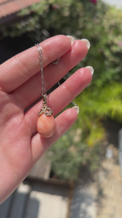 High-definition video capturing the soft, warm luster of the natural pink-orange coral drop, the fiery brilliance of the antique diamonds, and the rich, detailed 18k gold craftsmanship of the circa 1900 Victorian pendant in motion.
