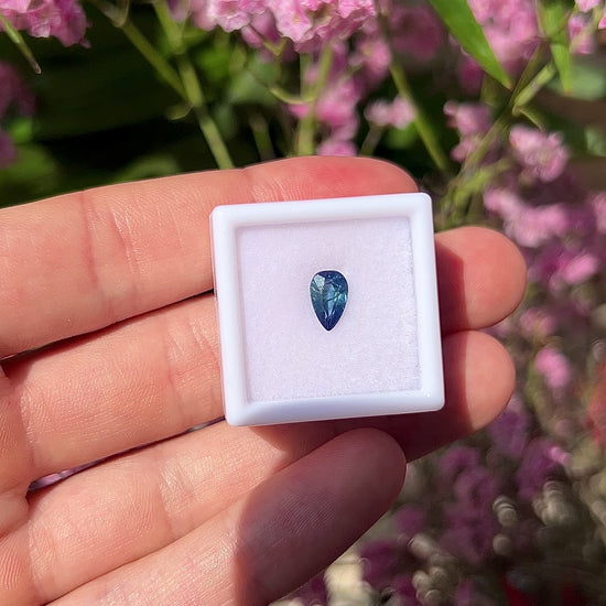 Video showing the lively brilliance, vivid blue flashes, and fiery teardrop-cut sparkle of the natural 1.40ct pear sapphire in motion.