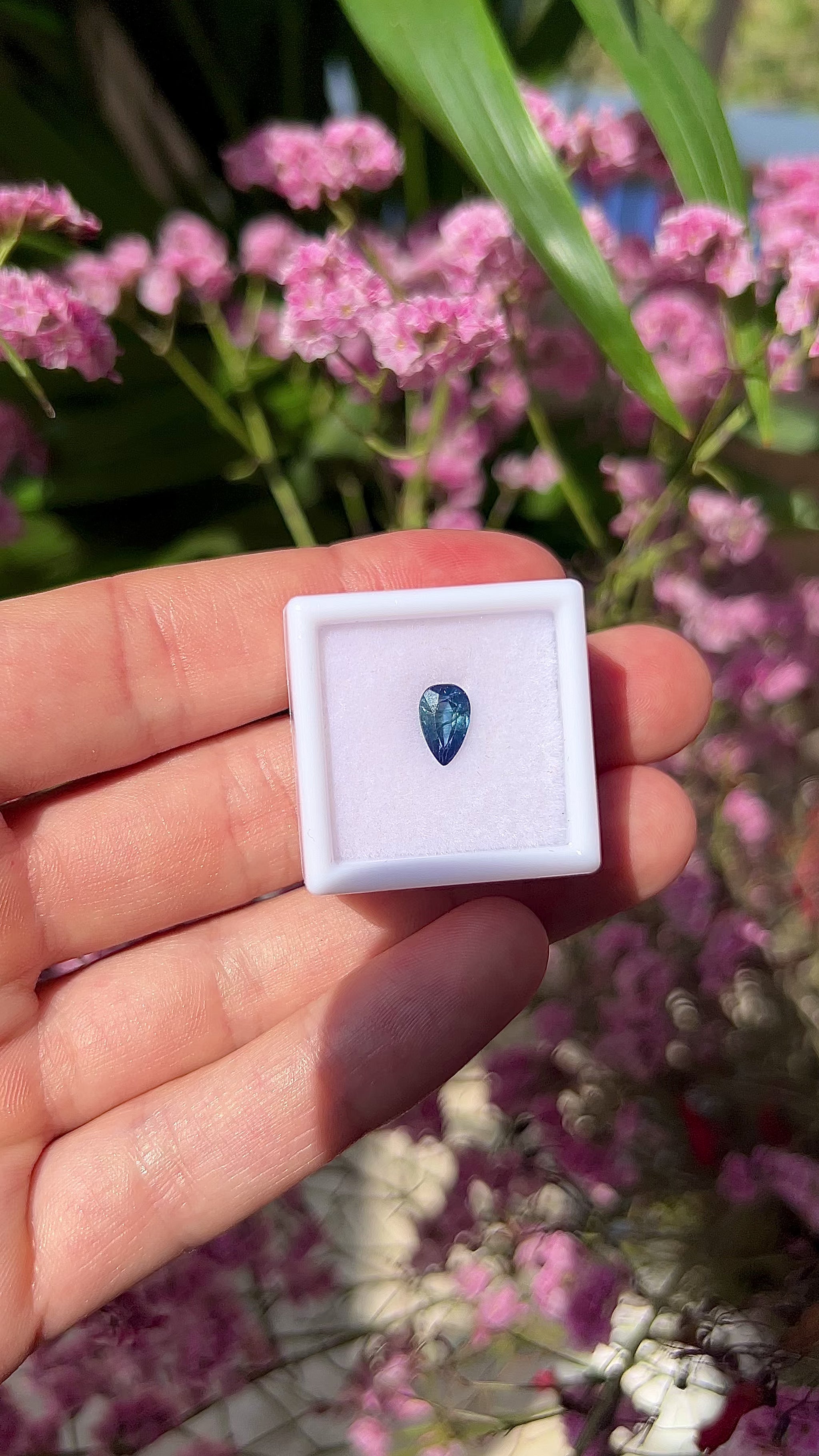 Video showing the lively brilliance, vivid blue flashes, and fiery teardrop-cut sparkle of the natural 1.40ct pear sapphire in motion.