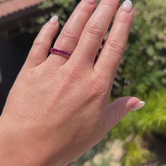 High-definition video capturing the seamless crimson red glow, fluid reflection of the 2.50-carat invisible-set rubies, and rich luster of the vintage 18k gold eternity ring in motion.