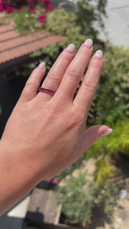 High-definition video capturing the seamless crimson red glow, fluid reflection of the 2.50-carat invisible-set rubies, and rich luster of the vintage 18k gold eternity ring in motion.