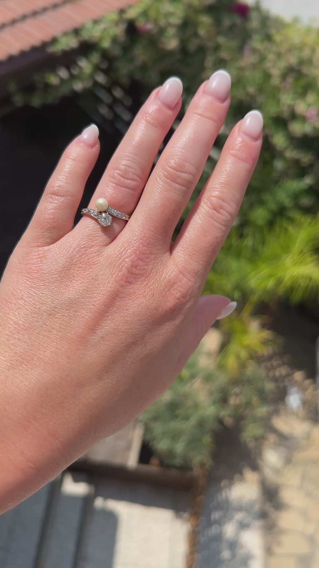 High-definition video capturing the fiery brilliance of the old-cut diamond, the soft iridescent glow of the natural pearl, and the elegant, romantic curvature of the circa 1900 Belle Époque 18k gold and platinum ring in motion.