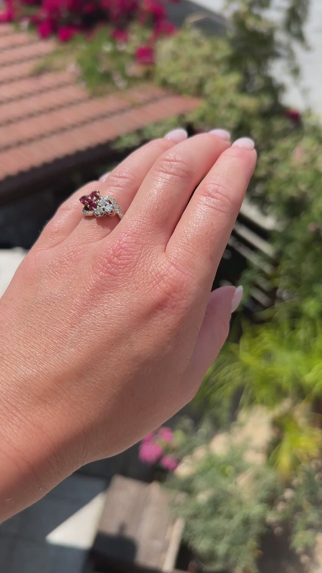 High-definition video capturing the rich crimson red glow of the ruby, the fiery brilliance of the old-cut diamonds, and the romantic clover shape of the antique Belle Époque Toi et Moi ring in motion.