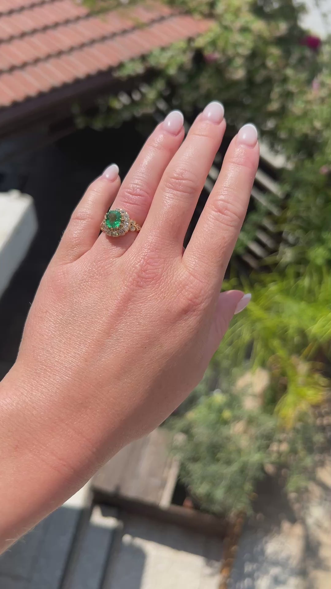 High-definition video capturing the intense green glow of the natural antique emerald, the fiery brilliance of the double diamond halo, and the regal presence of the Victorian era cocktail ring in motion.