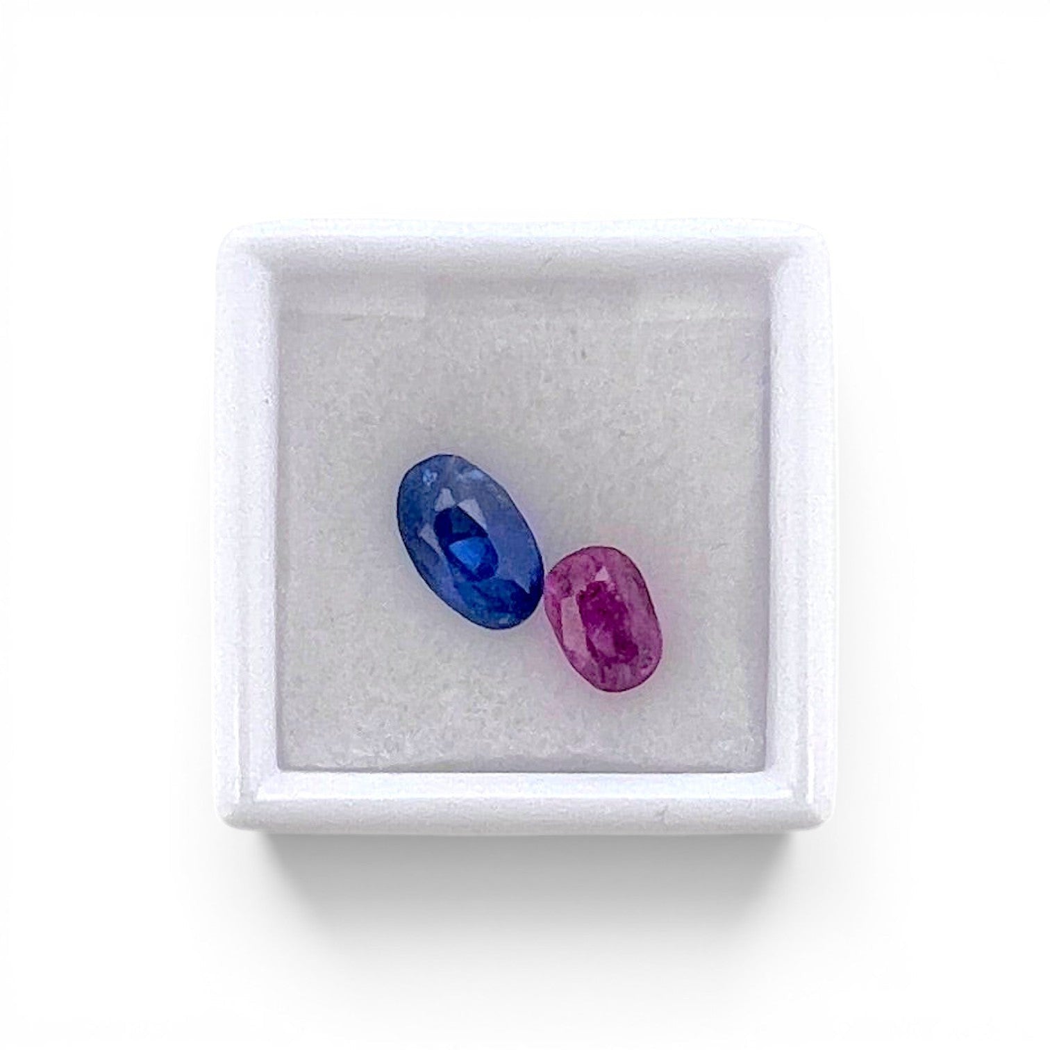 Pair of loose 5.00 carats total unheated old cut blue sapphires from Ceylon (Sri Lanka) displayed together inside a luxury presentation gem box by Antique Jewelry Finds.