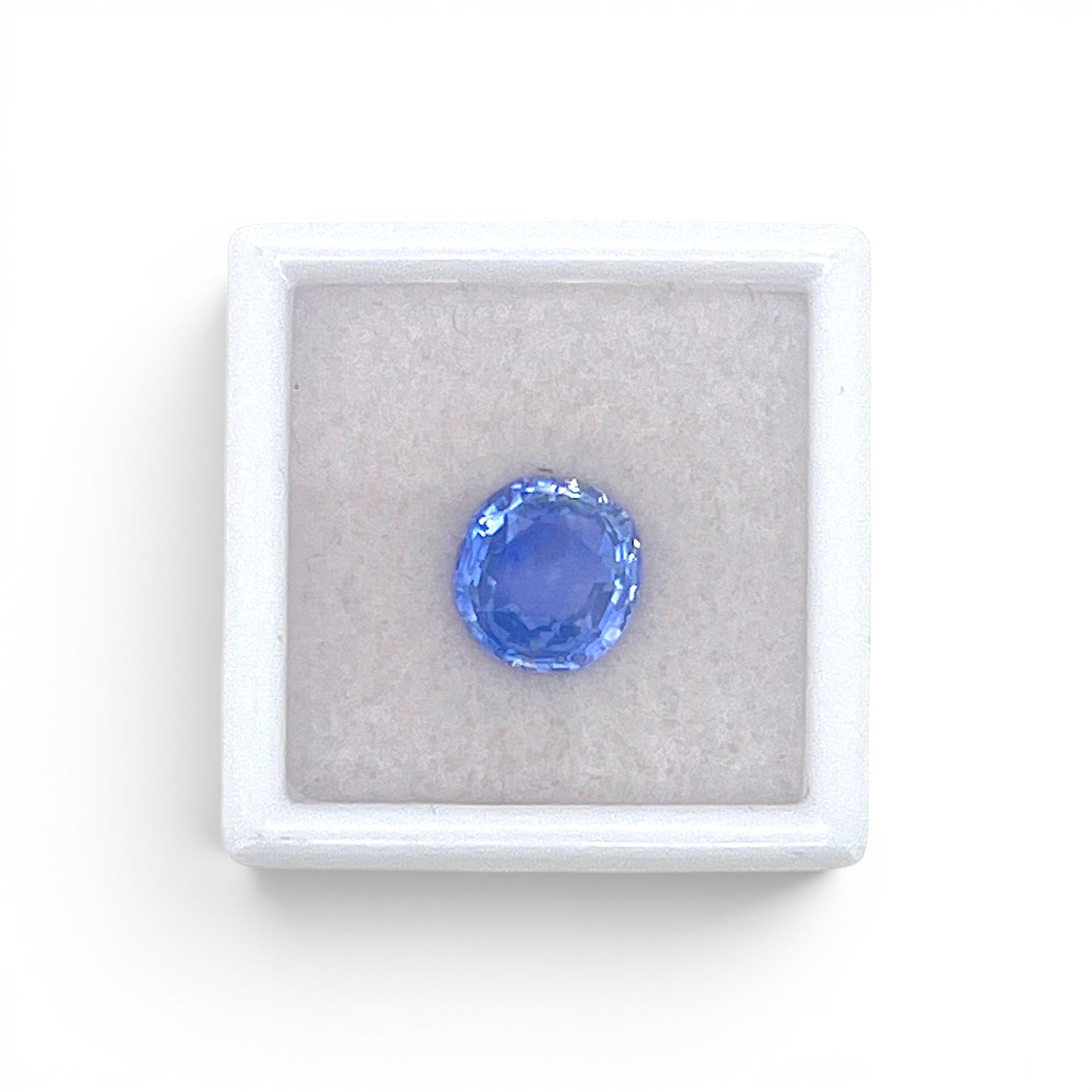 Loose 3.48 carat unheated natural round cushion cut blue sapphire gemstone from Ceylon (Sri Lanka) displayed inside a luxury presentation gem box by Antique Jewelry Finds.