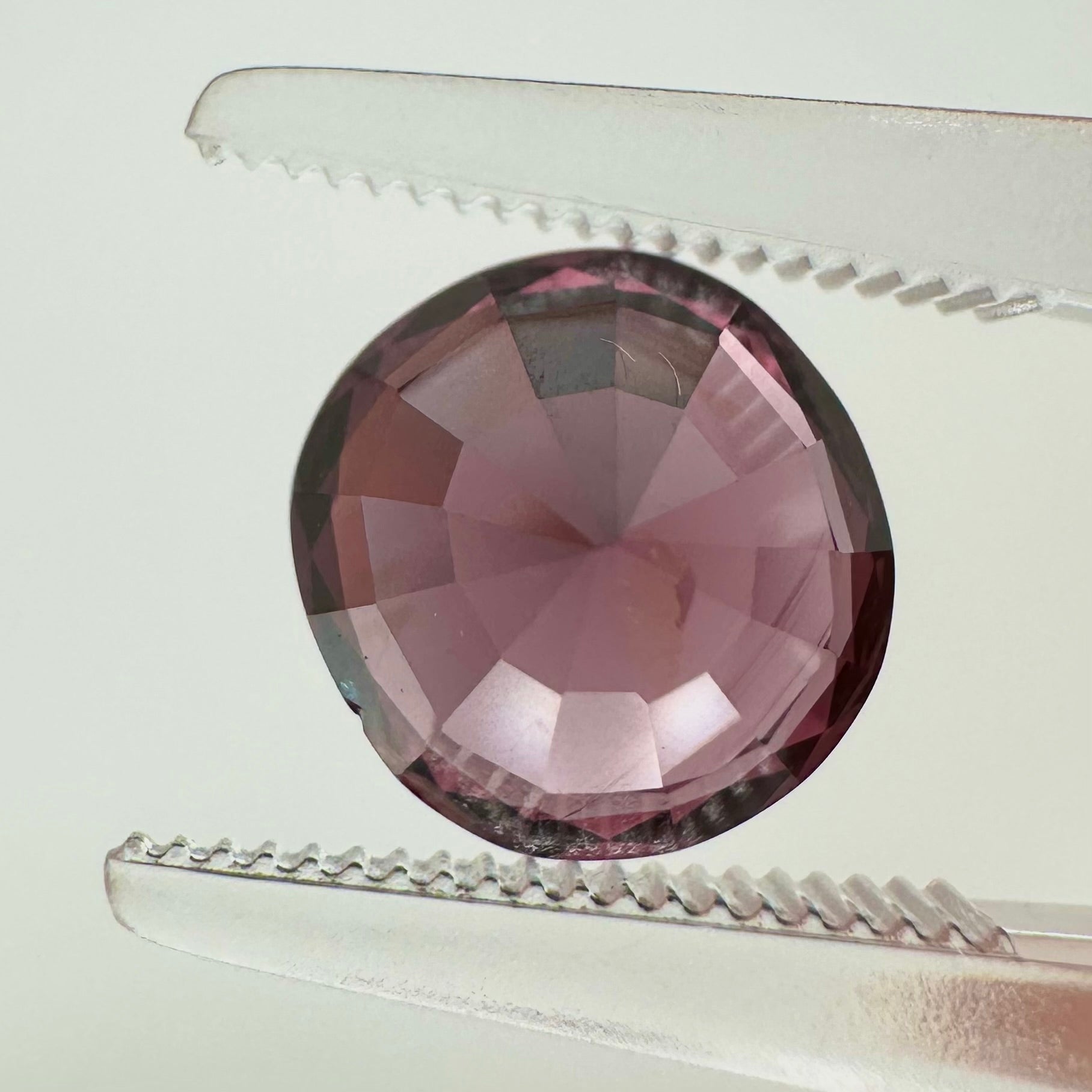 Reverse back view of the natural oval cushion deep pink spinel from Vietnam demonstrating its excellent clarity and lack of treatment.