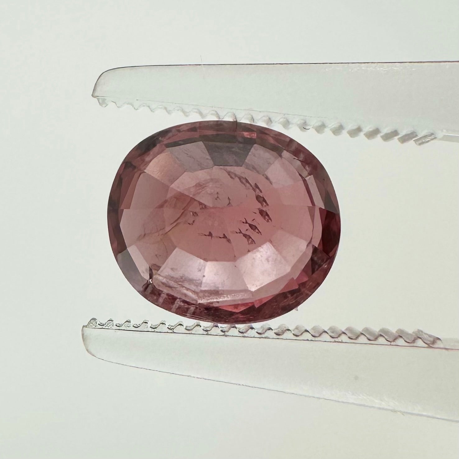 Reverse back view of the natural oval cushion deep pink spinel from Vietnam demonstrating its excellent clarity and lack of treatment.
