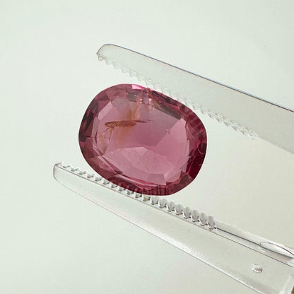 Reverse back view of the natural oval cushion electric pink orange spinel from Vietnam demonstrating its excellent clarity and lack of treatment