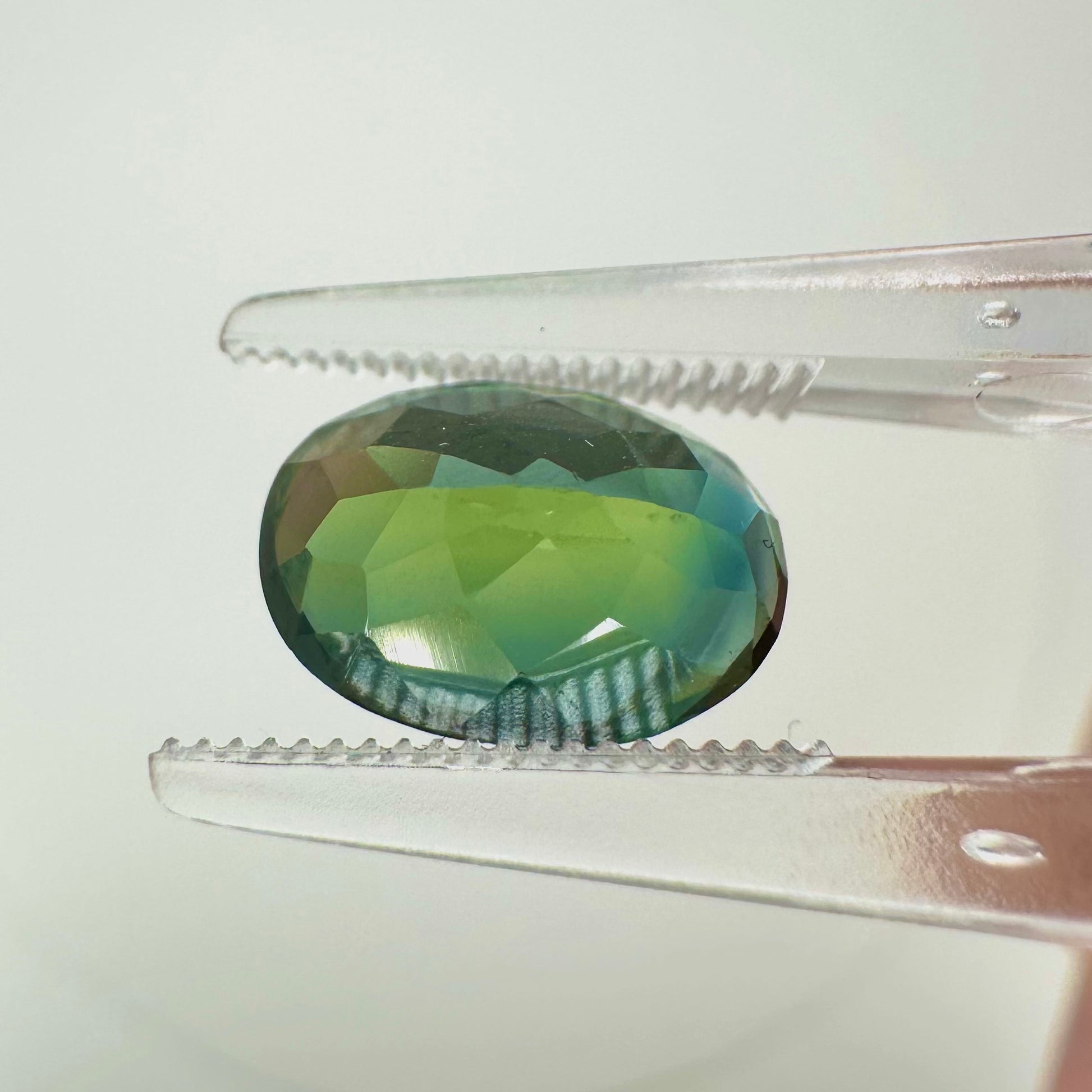 an other Reverse back view of the natural oval green sapphire demonstrating its excellent clarity, rich earthy tones, and lack of heat treatment.