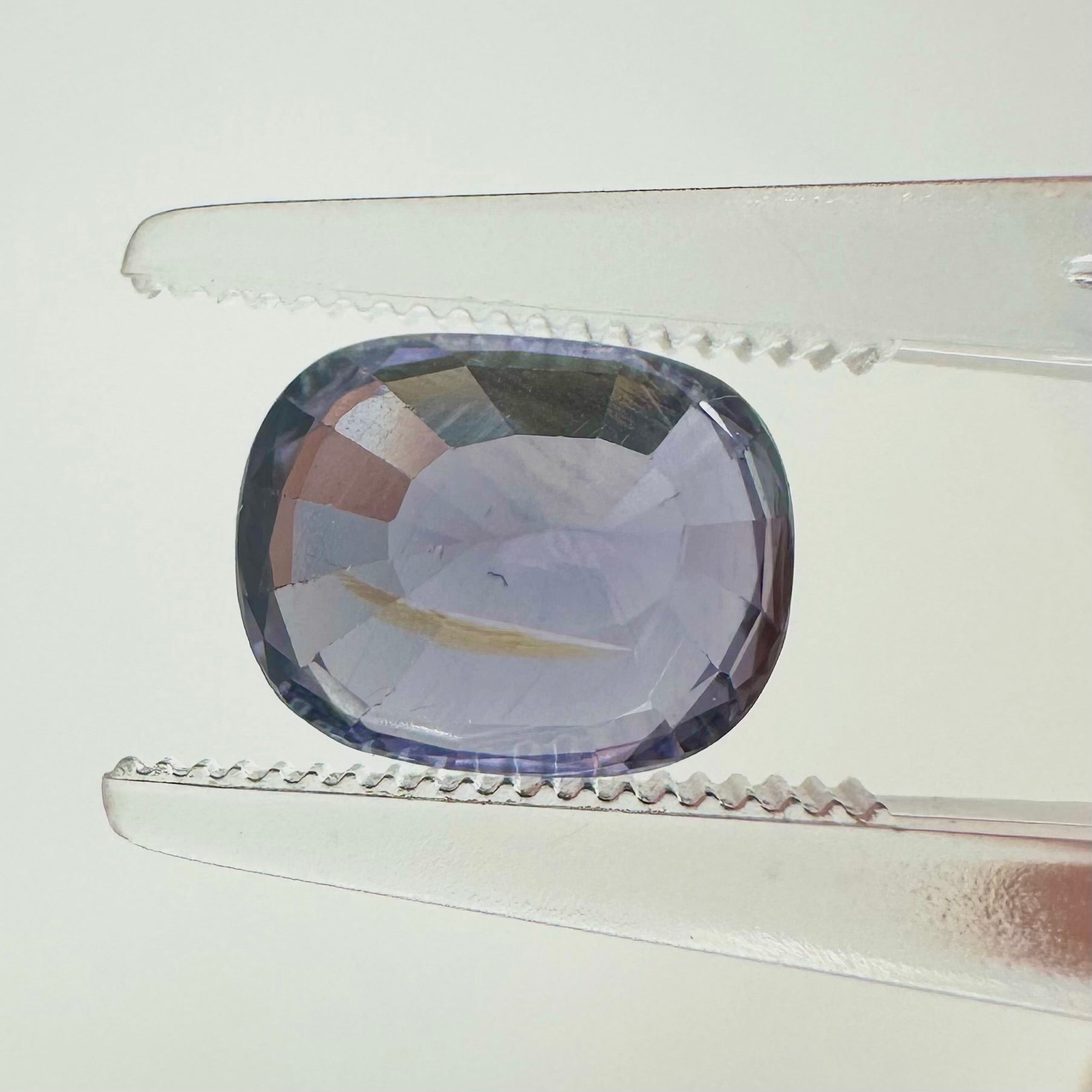 Reverse back view of the natural oval cushion lavender spinel from Vietnam demonstrating its excellent clarity and lack of treatment.