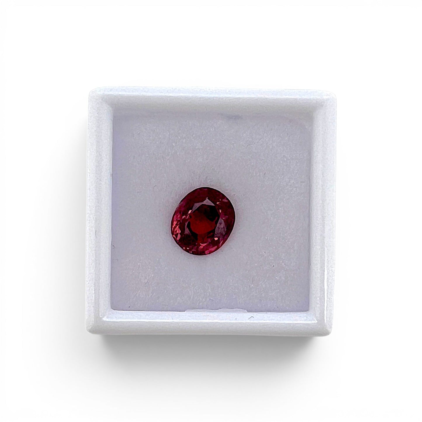 Loose 2.30 carat unheated deep pink spinel gemstone from Vietnam displayed inside a luxury presentation gem box by Antique Jewelry Finds.