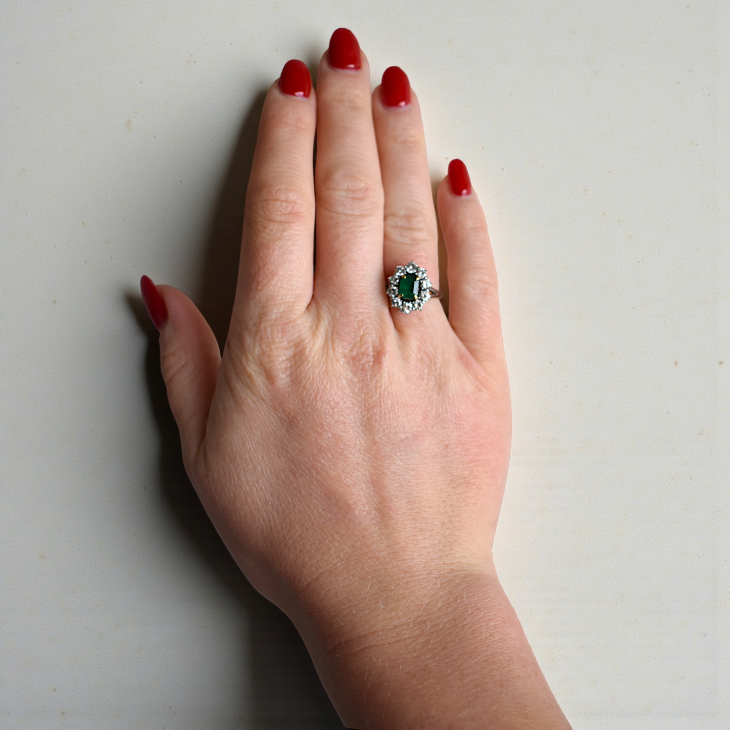 Vintage emerald and diamond Marguerite ring worn on a hand for scale and elegance