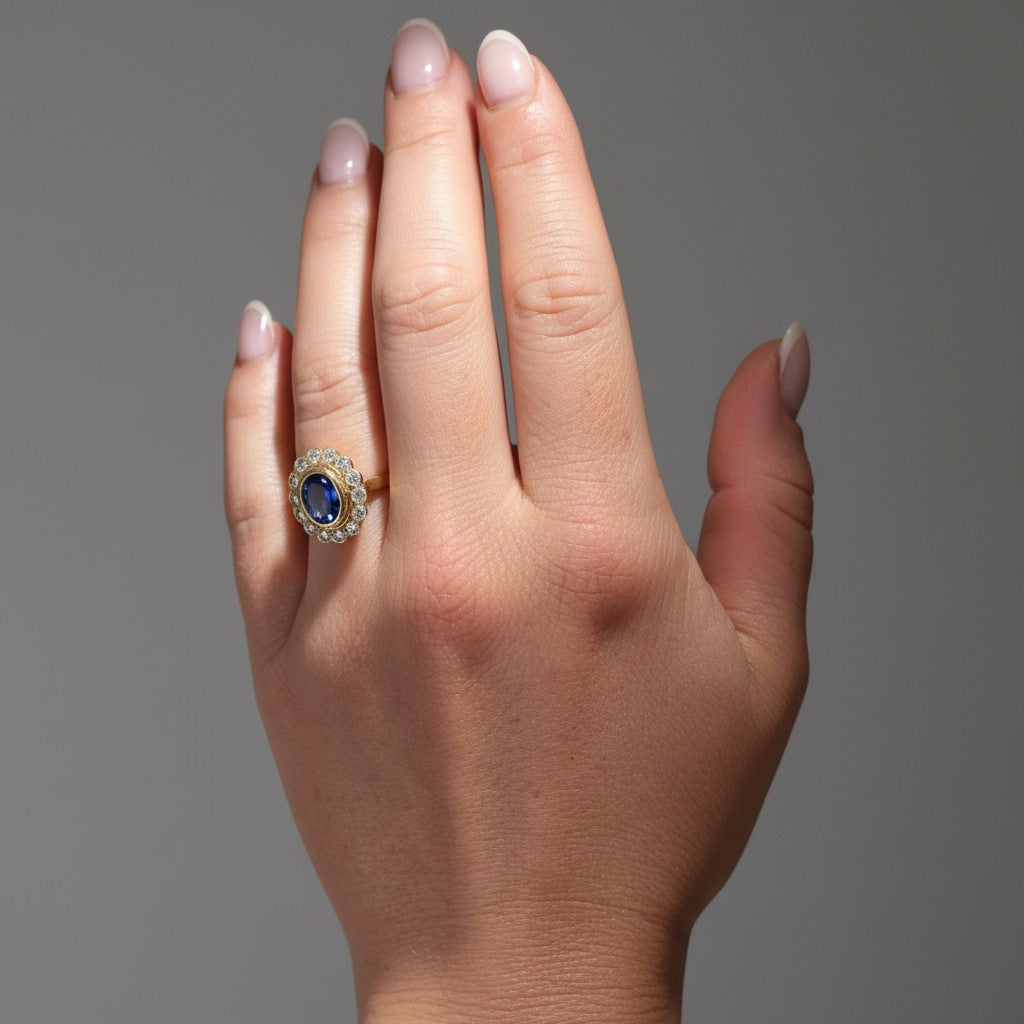 Classic 16x14mm sapphire and diamond marguerite cluster ring worn beautifully on a hand, size 5.25 US.
