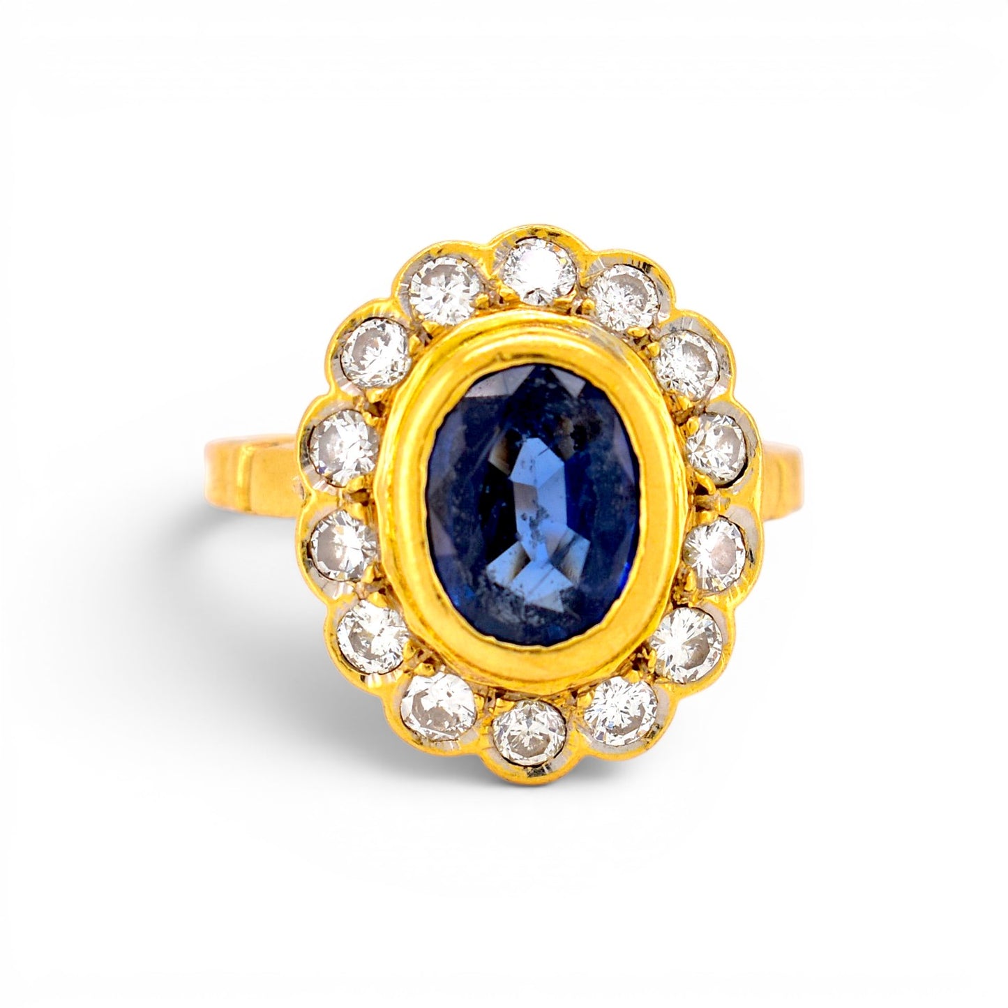 Vintage 1980s French 18k gold marguerite cluster ring with a 2ct blue sapphire and brilliant diamond halo by Antique Jewelry Finds.