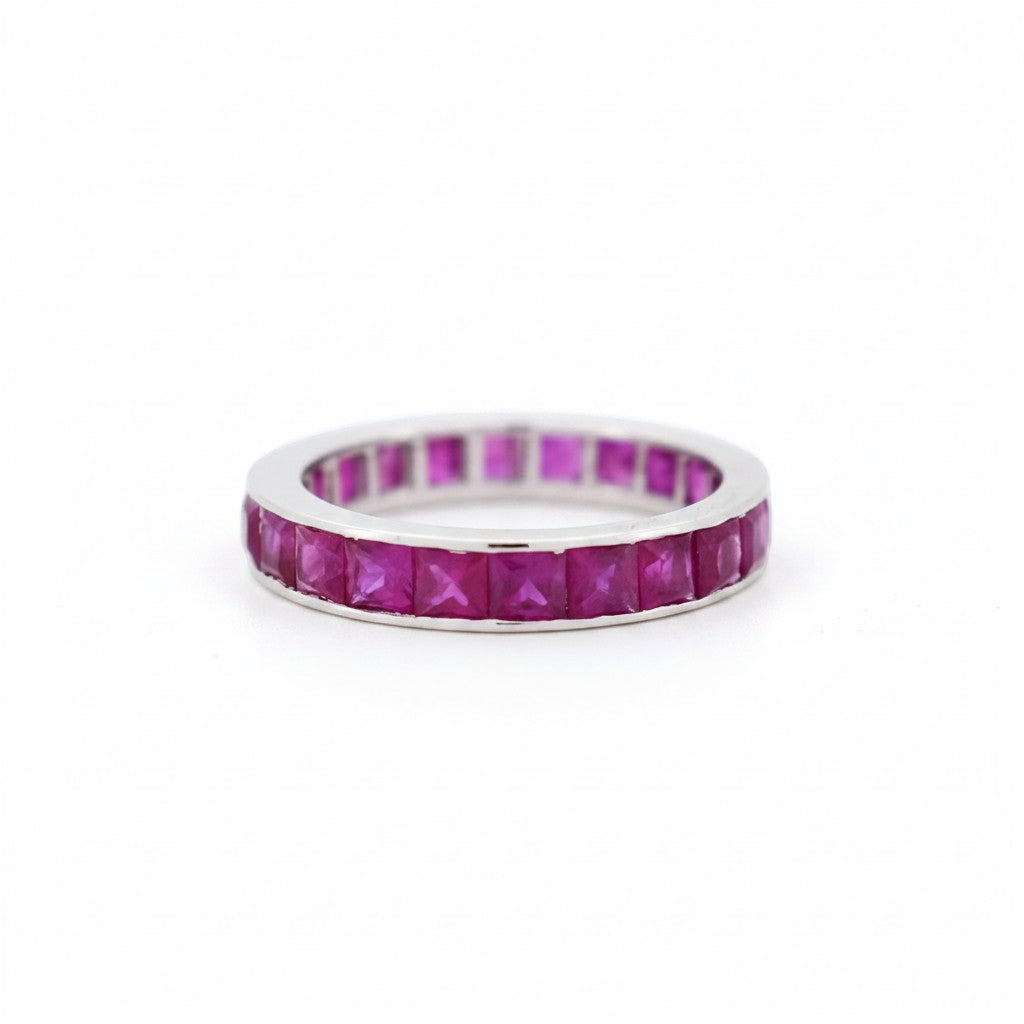 Top-down view showing the unbroken loop of 22 vibrant red princess cut rubies