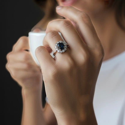 Vintage sapphire and diamond cluster ring worn on a hand for scale