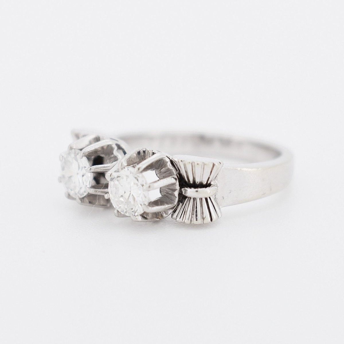 Close-up of the sculpted platinum and white gold ribbon work on a 1940s ring