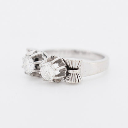 Close-up of the sculpted platinum and white gold ribbon work on a 1940s ring